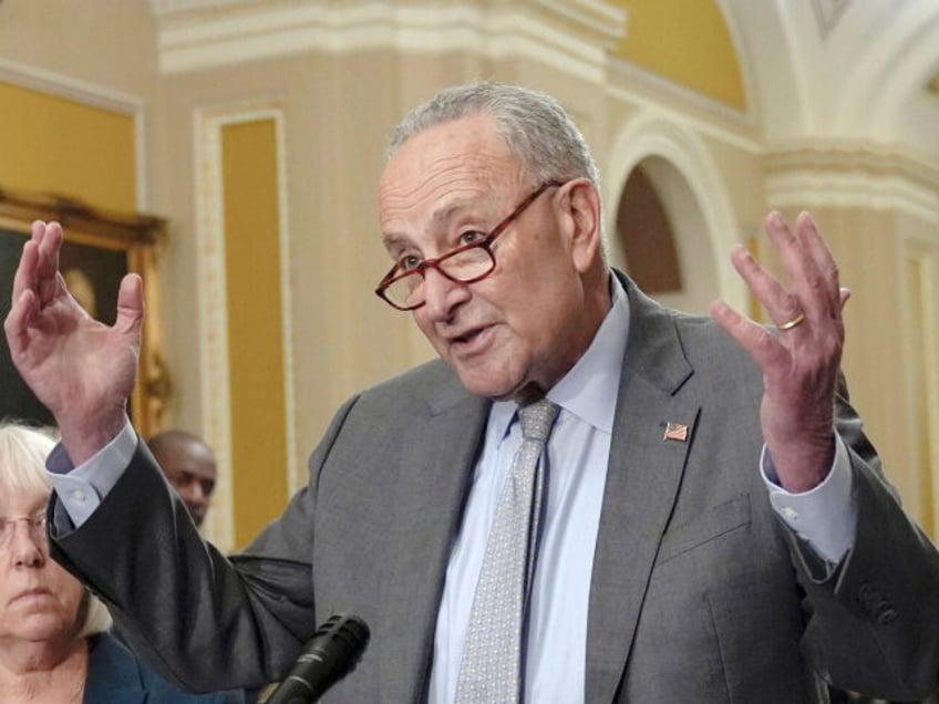 Sen. Majority Leader Chuck Schumer, D-N.Y., right, talks after a policy luncheon on Capito