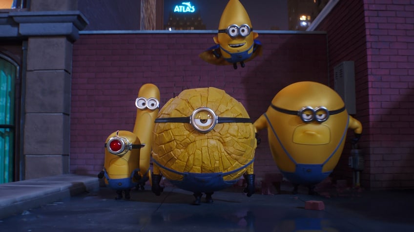 Minions appear in a scene from "Despicable Me 4" dressed as superheroes.