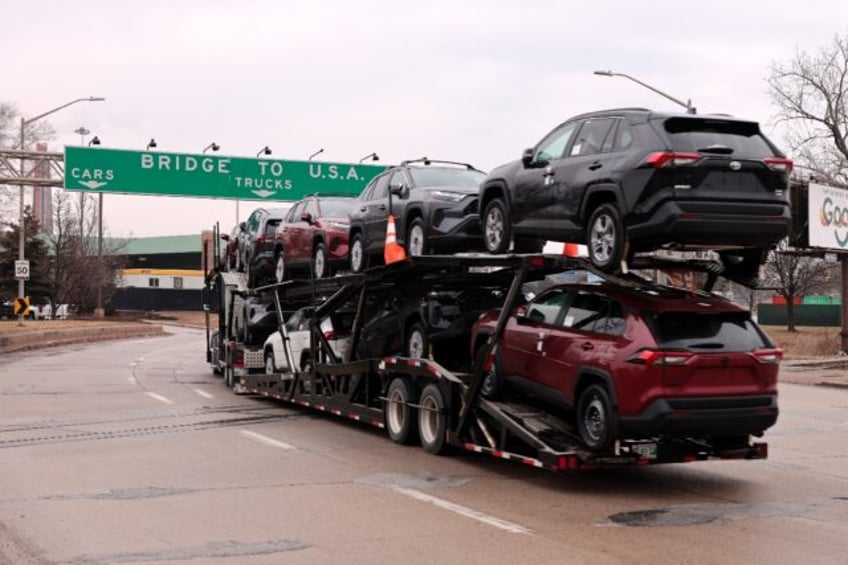 A car hauler carries Toyota RAV4 vehicles as it enters to cross the Ambassador Bridge in W