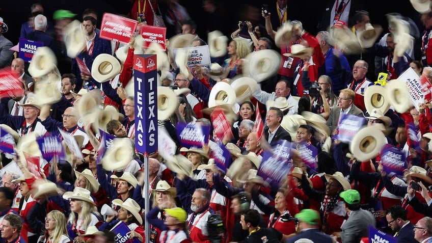 Attendees hold their hats on Day 3 of the Republican National Convention