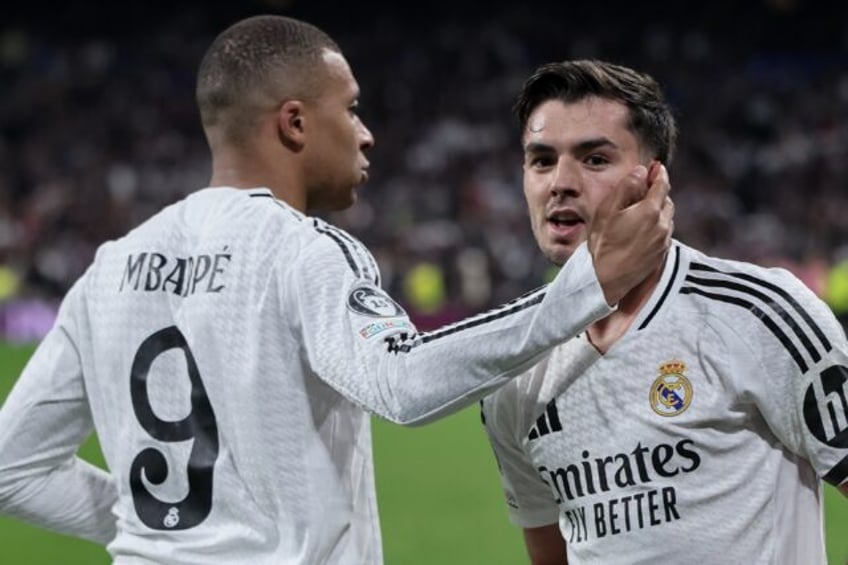 Real Madrid's Moroccan playmaker Brahim Diaz (R) celebrates scoring his team's second goal