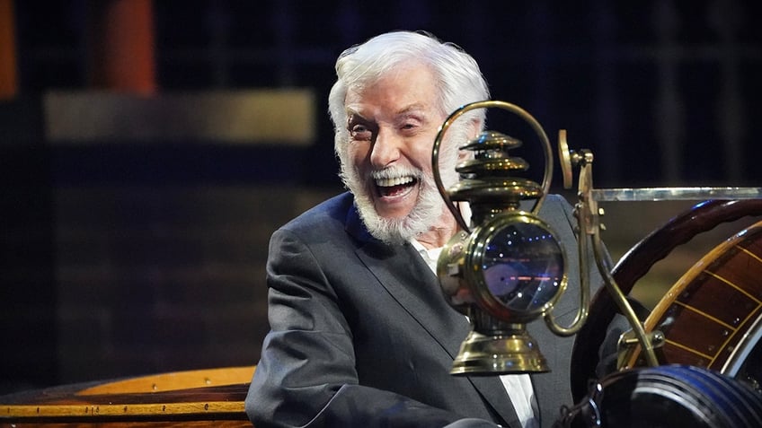 Dick Van Dyke sitting in a car on stage