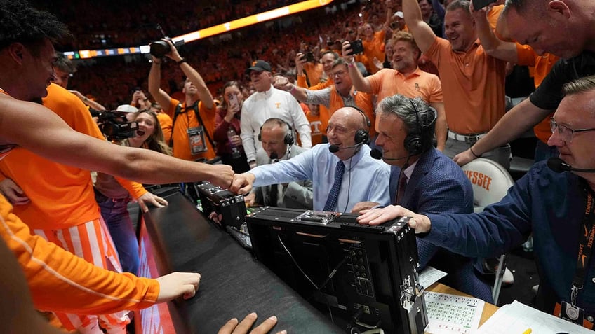 Tennessee players celebrate with Dick Vitale