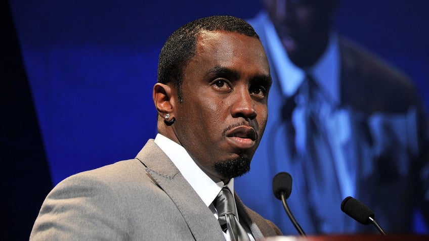Sean Diddy Combs wears grey suit with matching tie