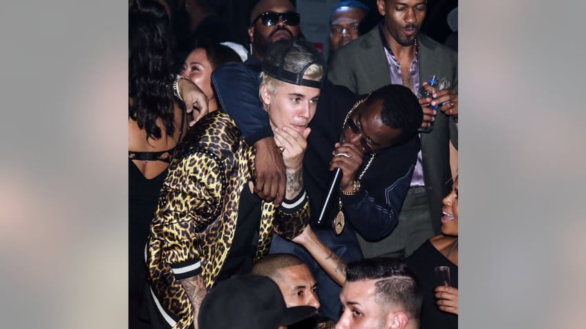 diddy with his arm around justin bieber