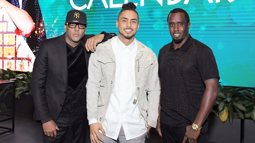 Quincy with his two fathers, Al B Sure! wearing a Yankees ahat and Sean Combs in black