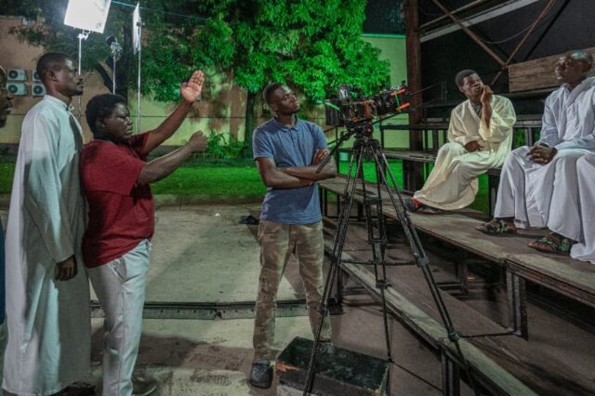 Democratic Republic of Congo film director Dieudo Hamadi (2nd L) makes films dealing with