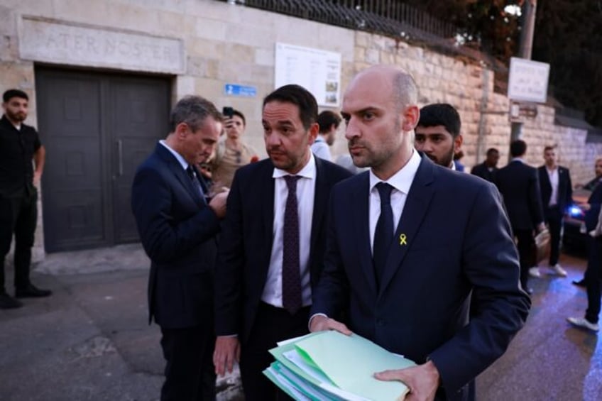 French Foreign Minister Jean-Noel Barrot (R) walks away after cancelling his scheduled vis