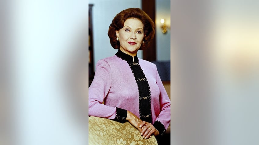 Kelly Bishop wearing a pink and black sweater