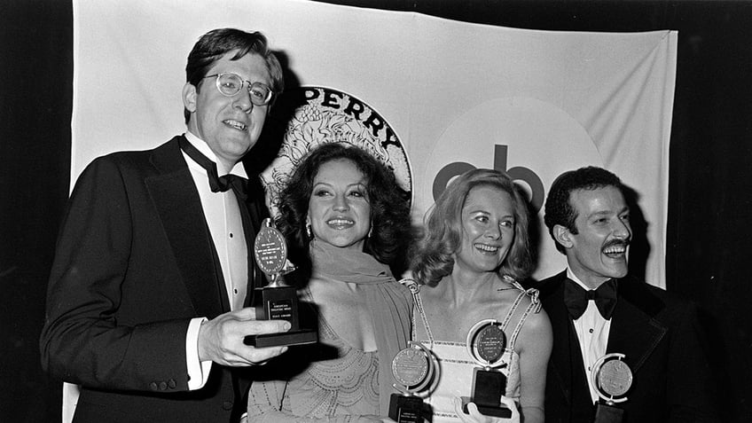 Kelly Bishop with her castmates holding Tony Awards.