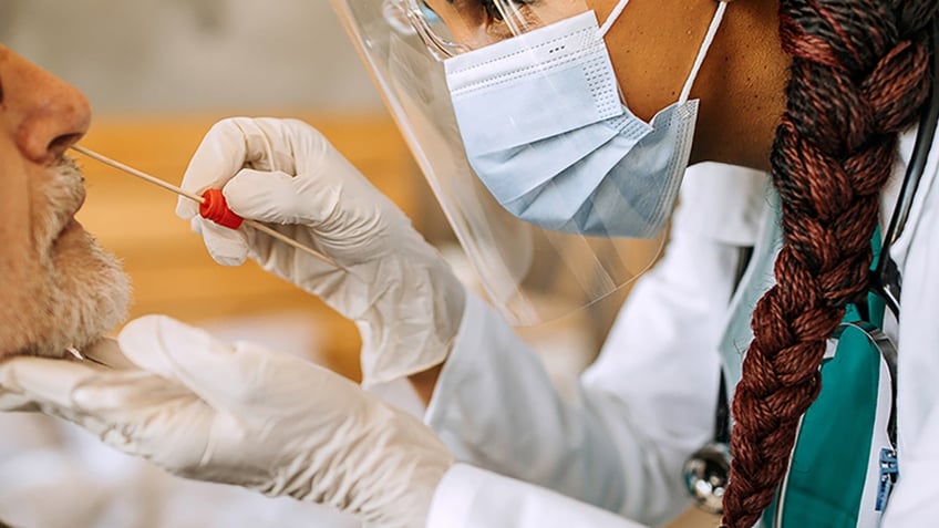 doctor swabbing patient