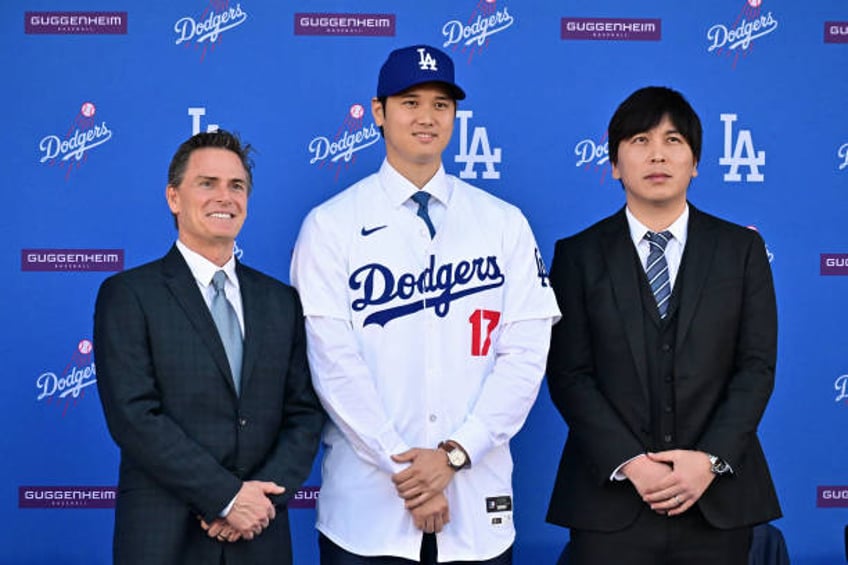 Japanese baseball player Shohei Ohtani poses with his agent Nez Balelo and Japanese interpreter Ippei Mizuhara during a press conference on his...