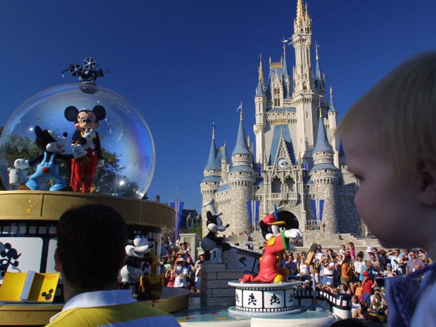 397155 08: Mickey Mouse rides in a parade through Main Street, USA with Cinderella's