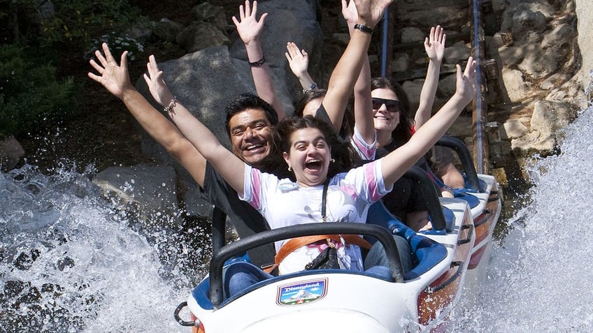 Mario Lopez and family on the Matterhorn Bobsleds.