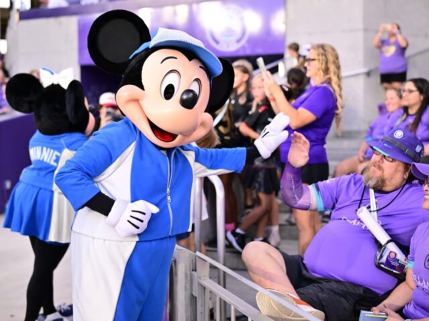 ORLANDO, FLORIDA - MAY 16: Disney's Mickey Mouse character greets fans prior to the NWSL m