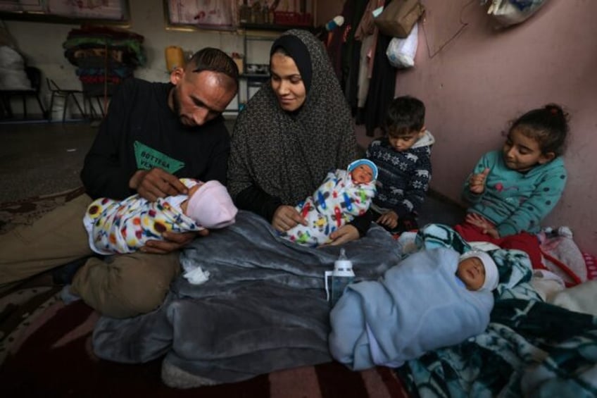 Displaced by war in Gaza Iman al-Masry is surrounded by her husband Ammar and her children including three of four babies born prematurely in the south of the war-devastated territory