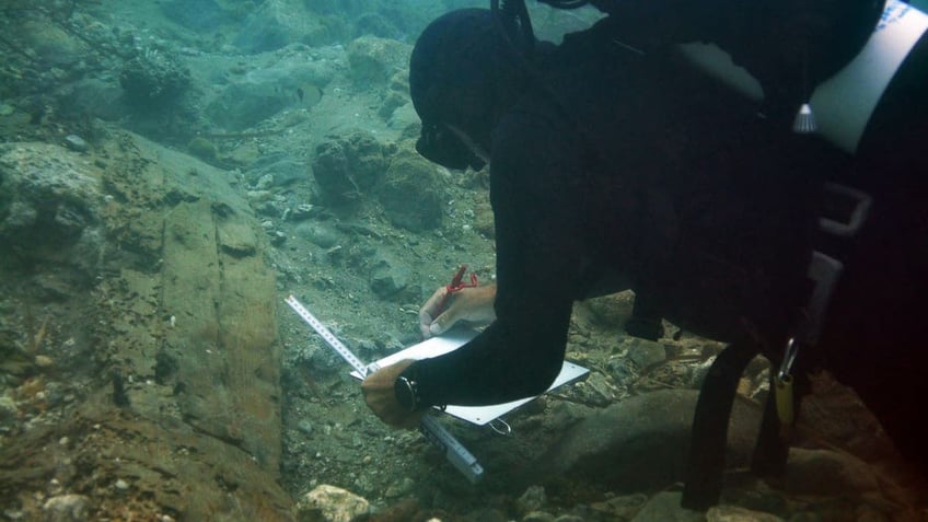 Diver working near shipwreck