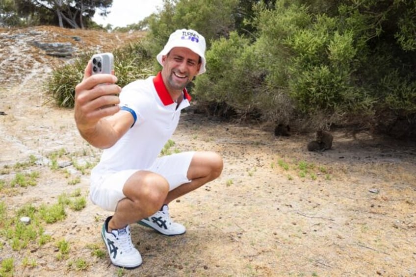 Novak Djokovic taking a selfie with a quokka on Rottnest Island in Australia