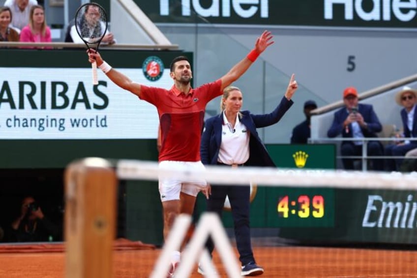 Serbia's Novak Djokovic (L) celebrates the winning point of his five-set victory over Fran