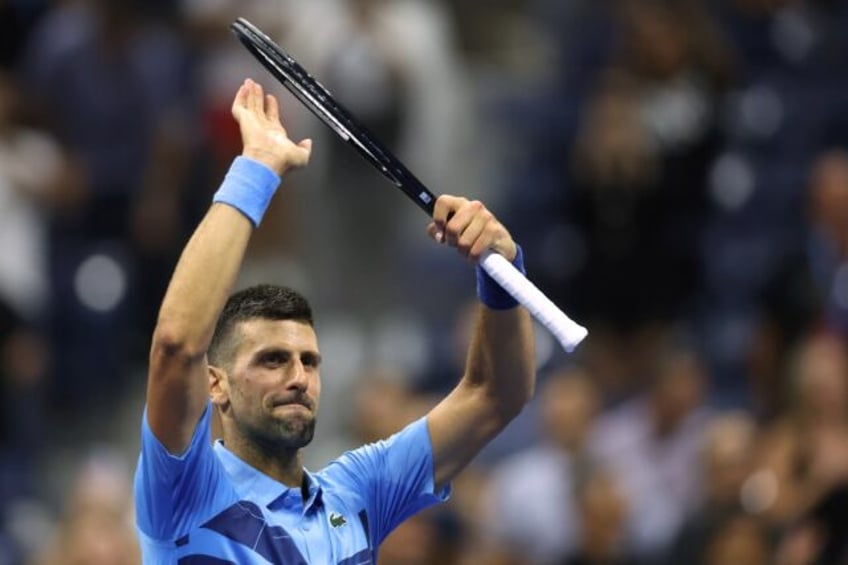 Defending champion Novak Djokovic acknowledges fans after his US Open first-round win over