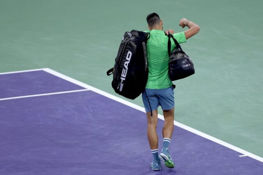 Heading for the exit: Novak Djokovic leaves the court after his shock third round defeat a