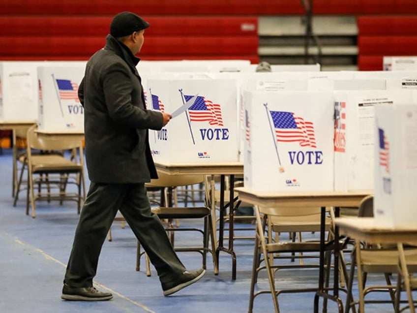 BEDFORD, NH - FEBRUARY 11: A voter walk to the voting booth at Bedford High School during the New Hampshire primary on February 11, 2020 in Bedford, New Hampshire. (Photo by Matthew Cavanaugh/Getty Images)