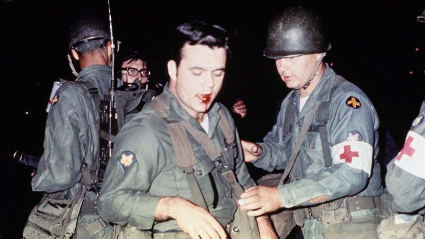 Chicago National Guardsman Michael Sturch is shown after he was hit in the mouth by a demonstrator during protests outside the Democratic National Convention