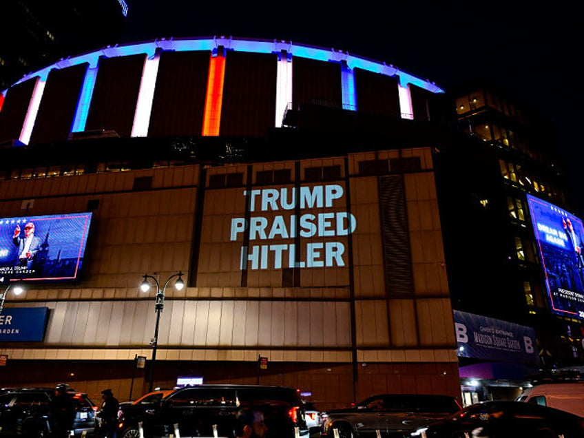 NEW YORK, NEW YORK - OCTOBER 27: The DNC projects a message reading "Trump Praised Hitler"