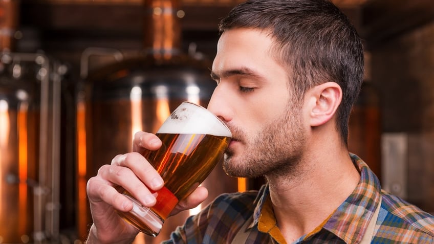 A man drinking beer.