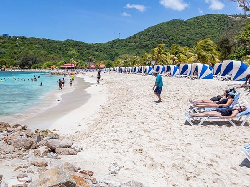 Cruise passengers at the beach on Royal Caribbean's private coastal peninsula of Labadee,