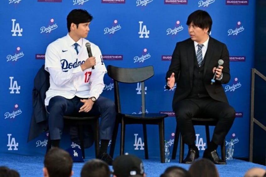 Japanese baseball player Shohei Ohtani (left) speaks alongside Japanese interpreter Ippei