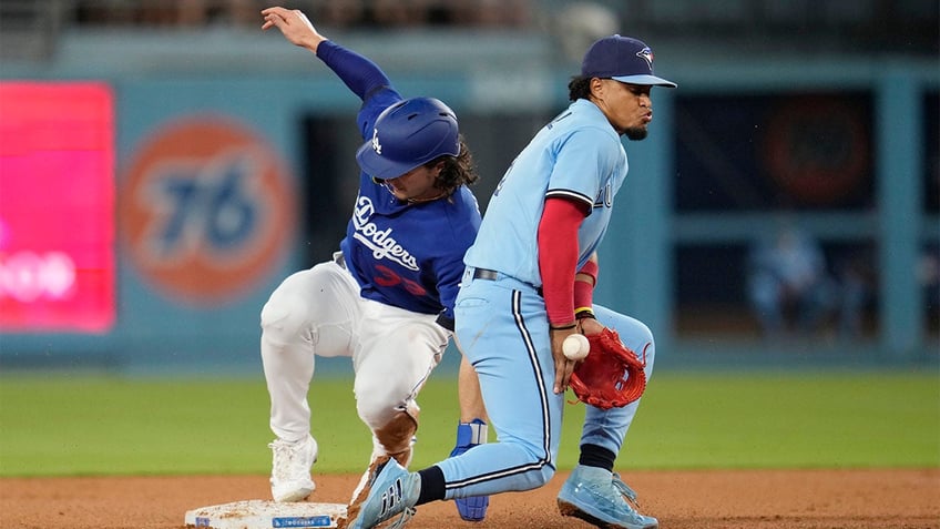 dodgers rally for four runs in ninth inning walk off blue jays in tenth inning on james outmans double