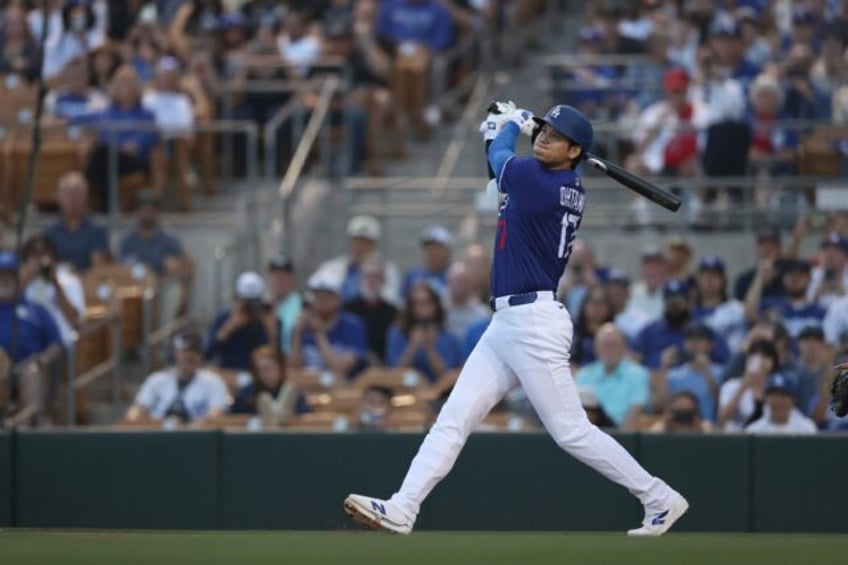 Shohei Ohtani of the Los Angeles Dodgers hits a home run in the first inning of the team's