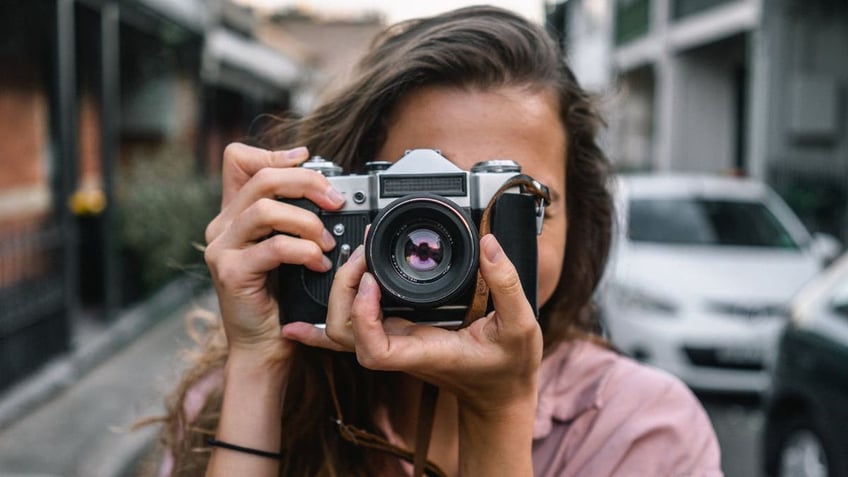 woman holding digital camera