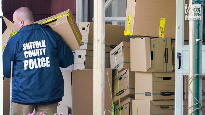 New York State and Suffolk County investigators remove bags of items marked with evidence tape from Rex Heuermann’s home in Massapequa Park