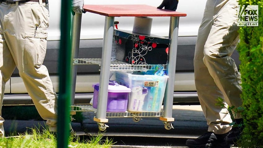 New York State and Suffolk County investigators remove items from Rex Heuermann’s home in Massapequa Park