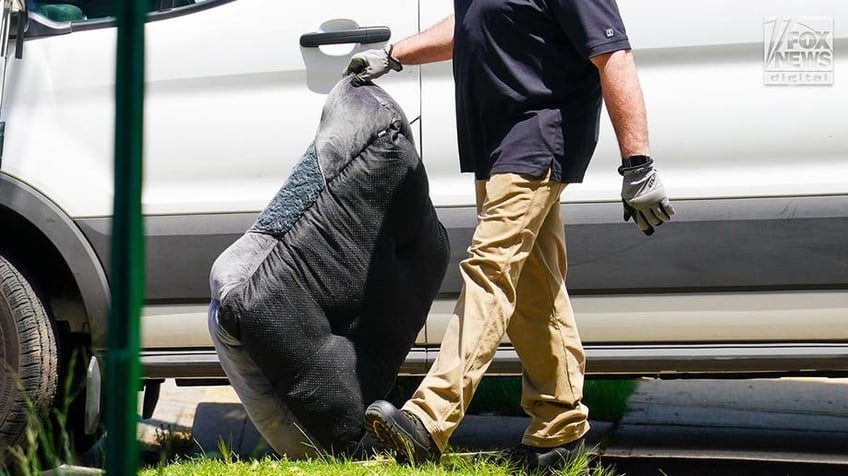 New York State and Suffolk County investigators remove items from Rex Heuermann’s home in Massapequa Park