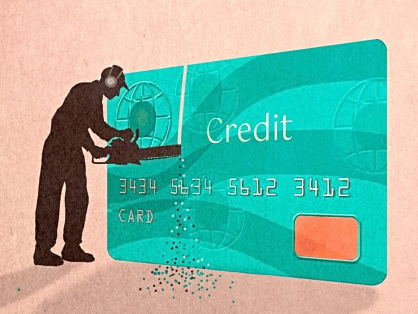 Silhouette man cutting credit card with chainsaw