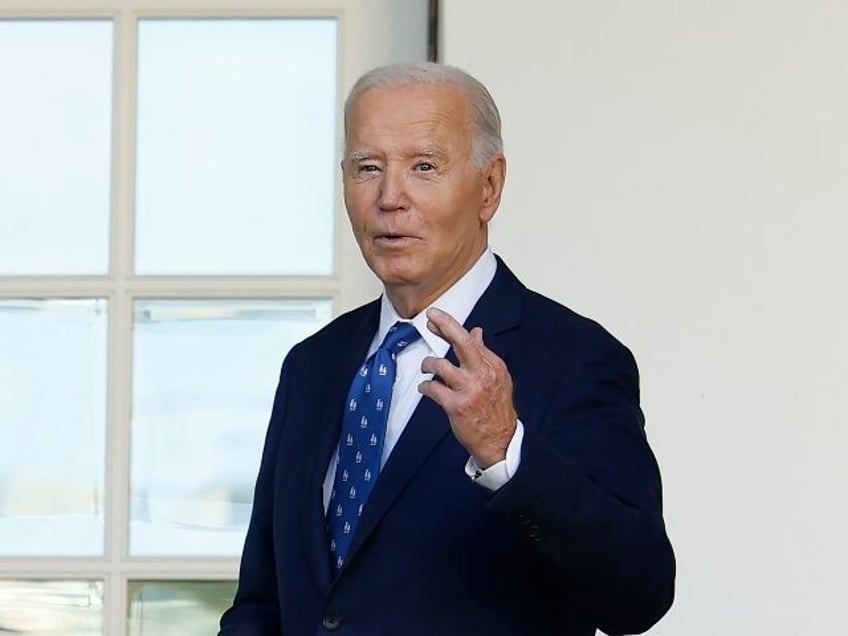 WASHINGTON, DC - NOVEMBER 26: U.S. President Joe Biden crosses his fingers as he responds