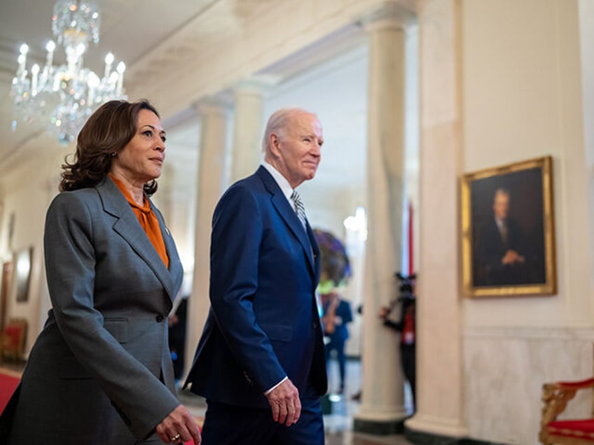 President Joe Biden and Vice President Kamala Harris walk through the Cross Hall as they a