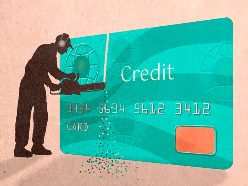 Silhouette man cutting credit card with chainsaw