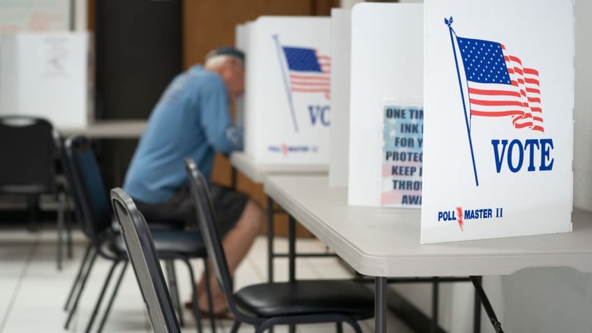 A man fills out a ballot at a voting booth on May 17, 2022 in Mt. Gilead, North Carolina.