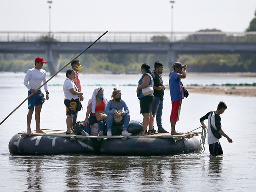 People cross the Suchiate River, border between Guatemala and Mexico, into Mexico aboard a