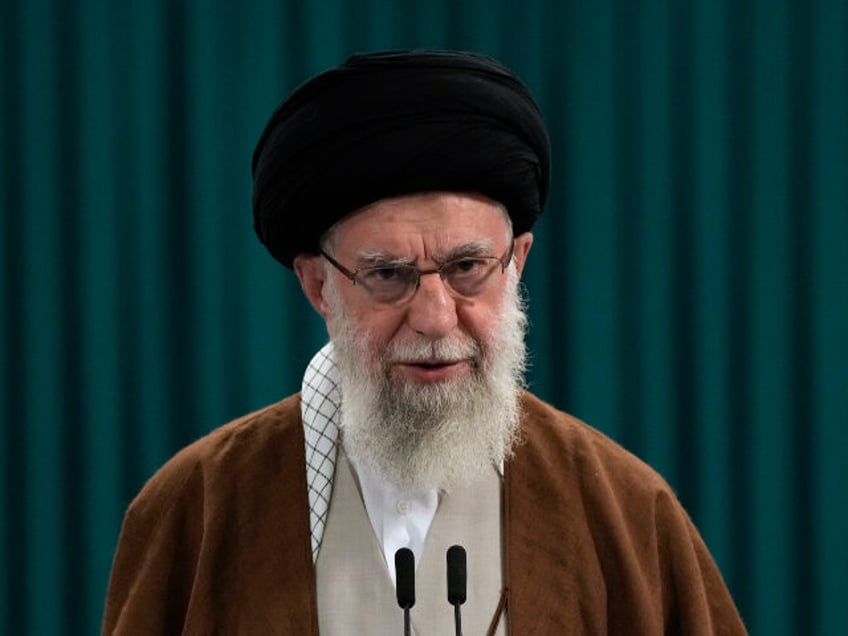 Iranian Supreme Leader Ayatollah Ali Khamenei speaks with media members after he voted for