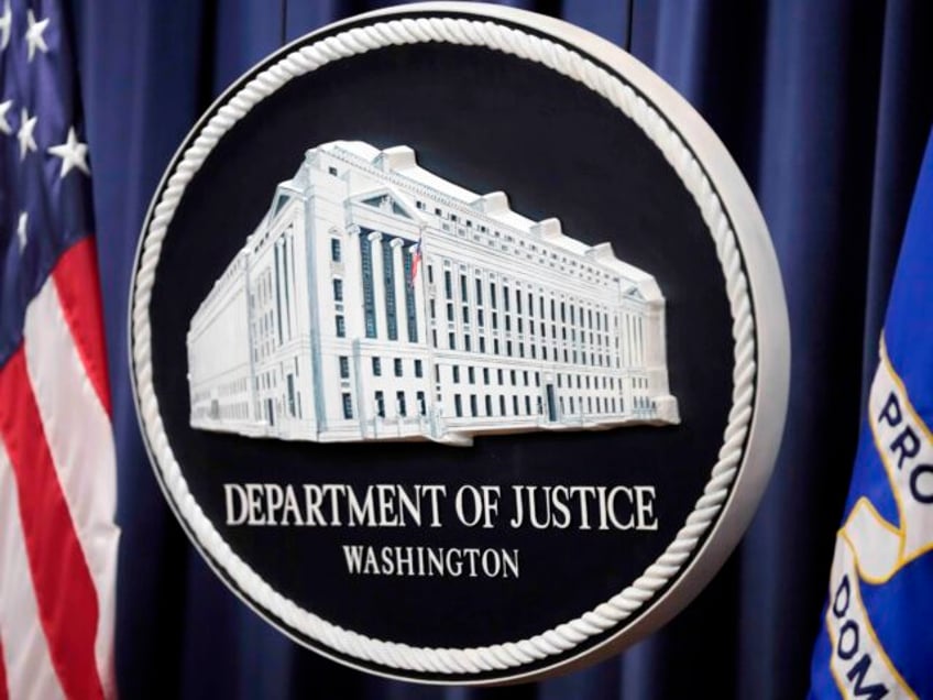 FILE - The logo for the Justice Department is seen before a news conference at the Departm