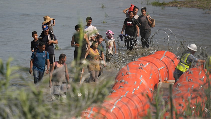 doj to sue texas over floating border barrier abbott says see you in court