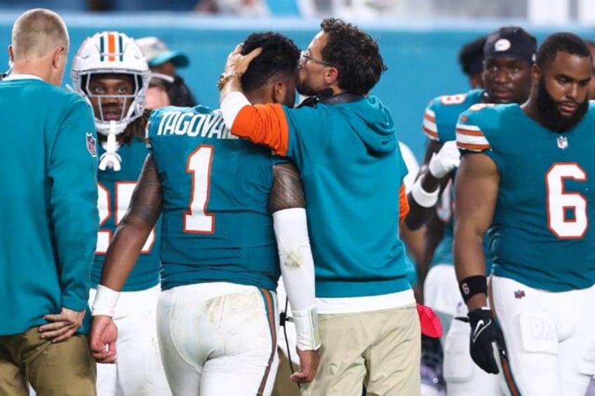 Miami quarterback Tua Tagovailoa (1) walks off the field following his concussion against