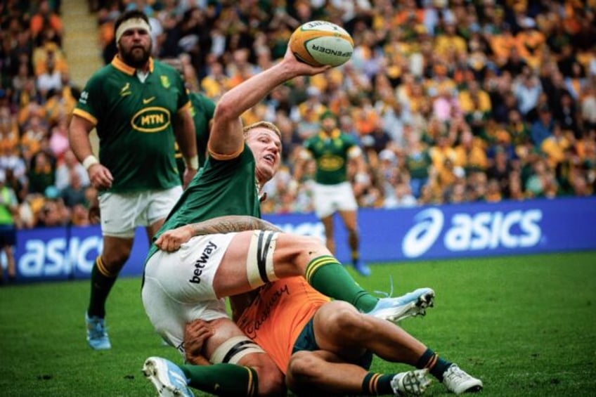 South Africa's Pieter-Steph du Toit (left) looks to offload as he is tackled by Australia'