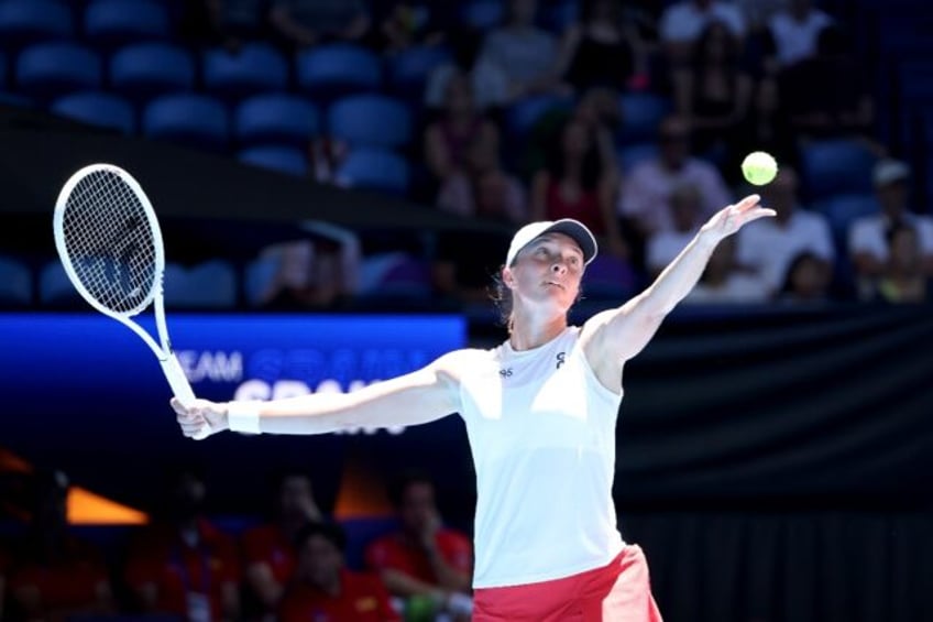 Poland’s dominant Iga Swiatek serves against Spain’s Sara Sorribes Tormo at the United Cup