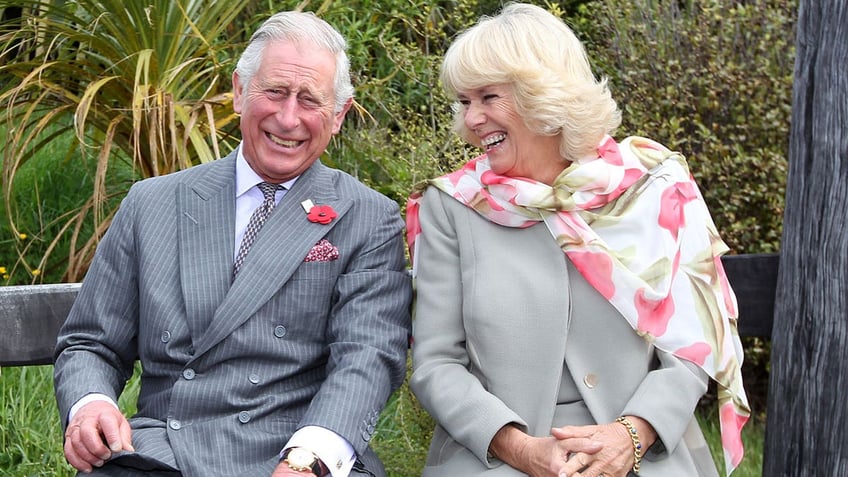 King Charles laughing with wife Camilla
